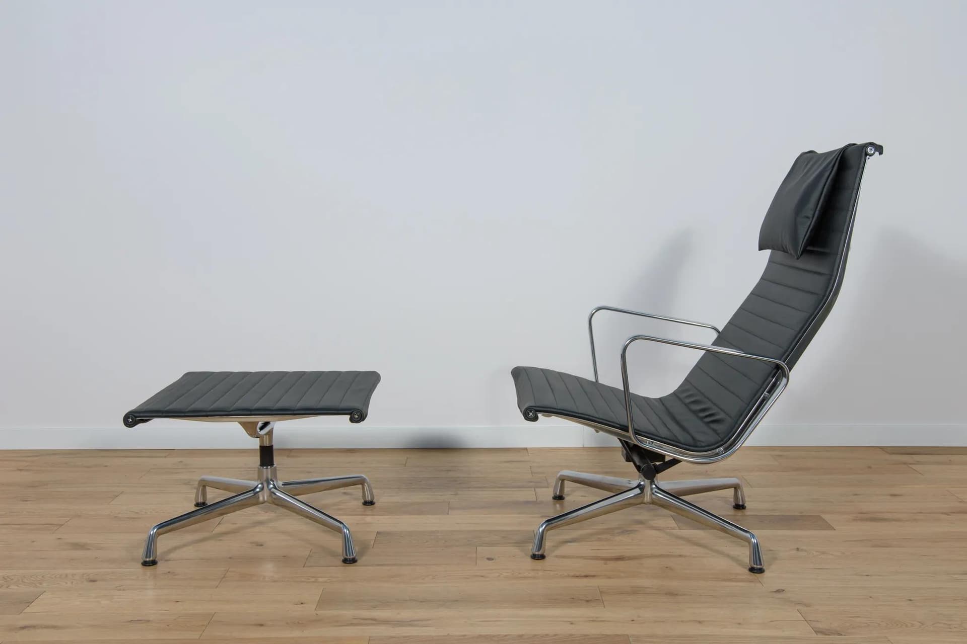 Lounge chair and ottoman EA124 & EA125, black leather, aluminium, by C. & R. Eames, Vitra, Germany, 1980s. - 70066