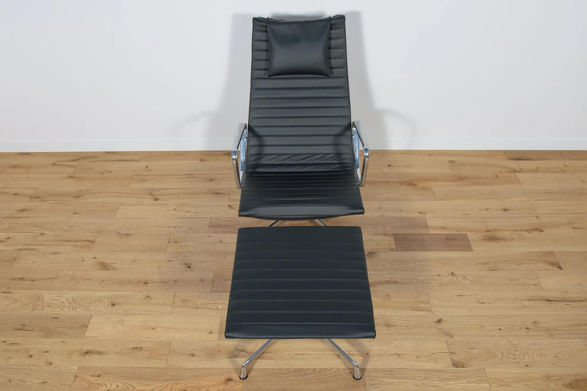 Lounge chair and ottoman EA124 & EA125, black leather, aluminium, by C. & R. Eames, Vitra, Germany, 1980s. - 70063