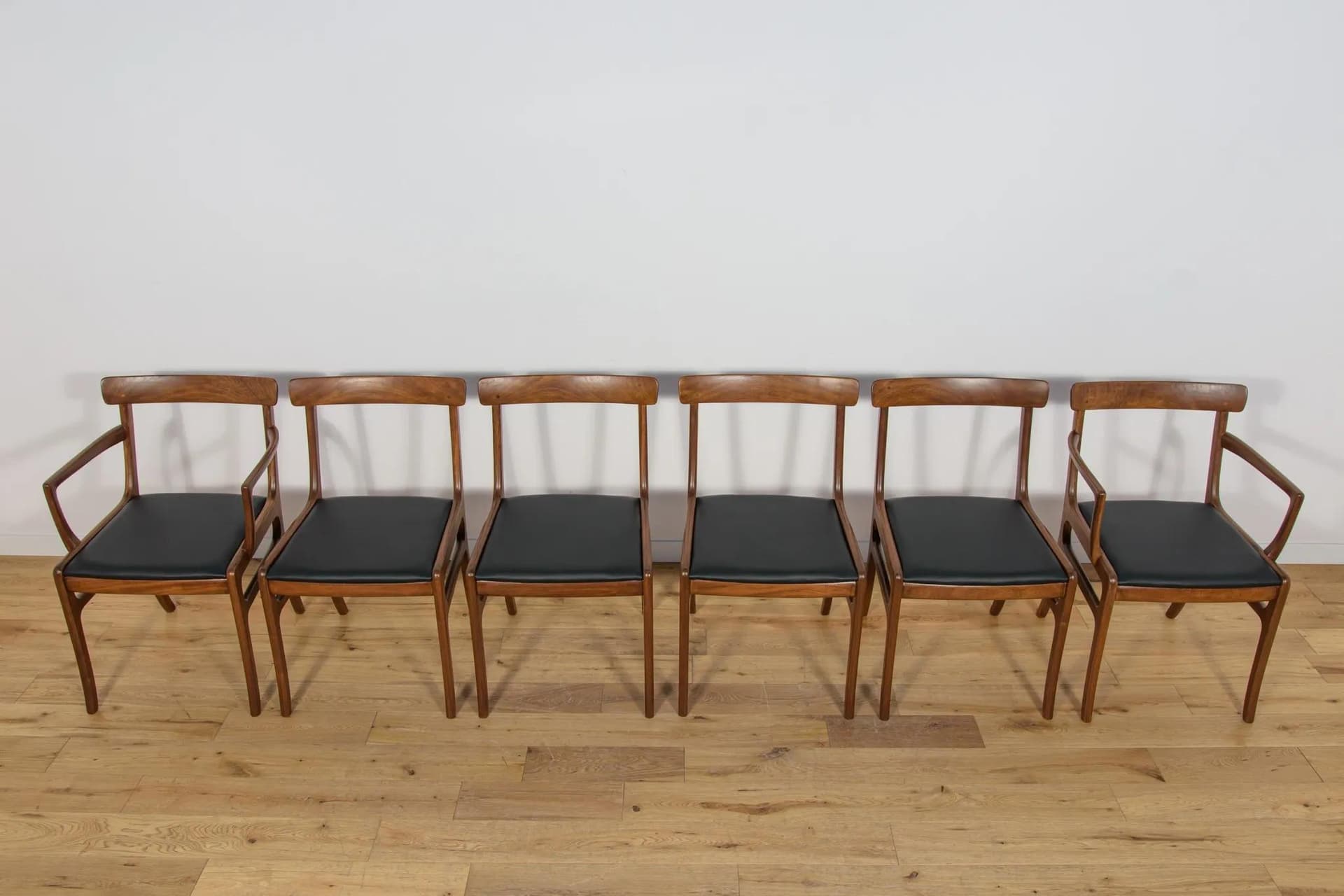 Set of Four Chairs and Two Armchairs Rungstedlund, brown mahogany, black leather, by O. Wanscher, Poul Jeppesens Møbelfabrik, Denmark, 1960s. - 75020