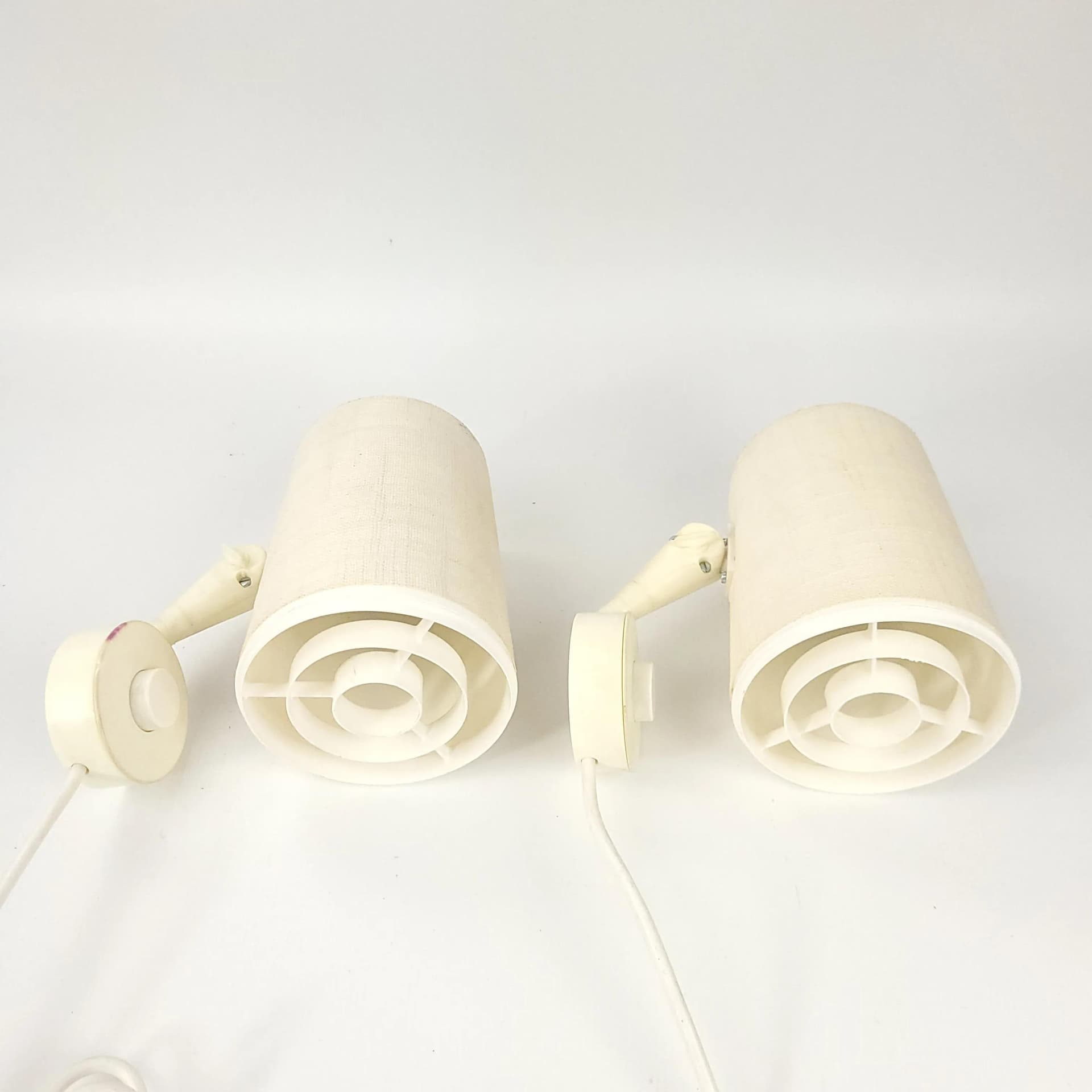 Pair of wall sconces Elidus, ivory white, fabric, metal, plastic, Sweden, 1970s. - 85402