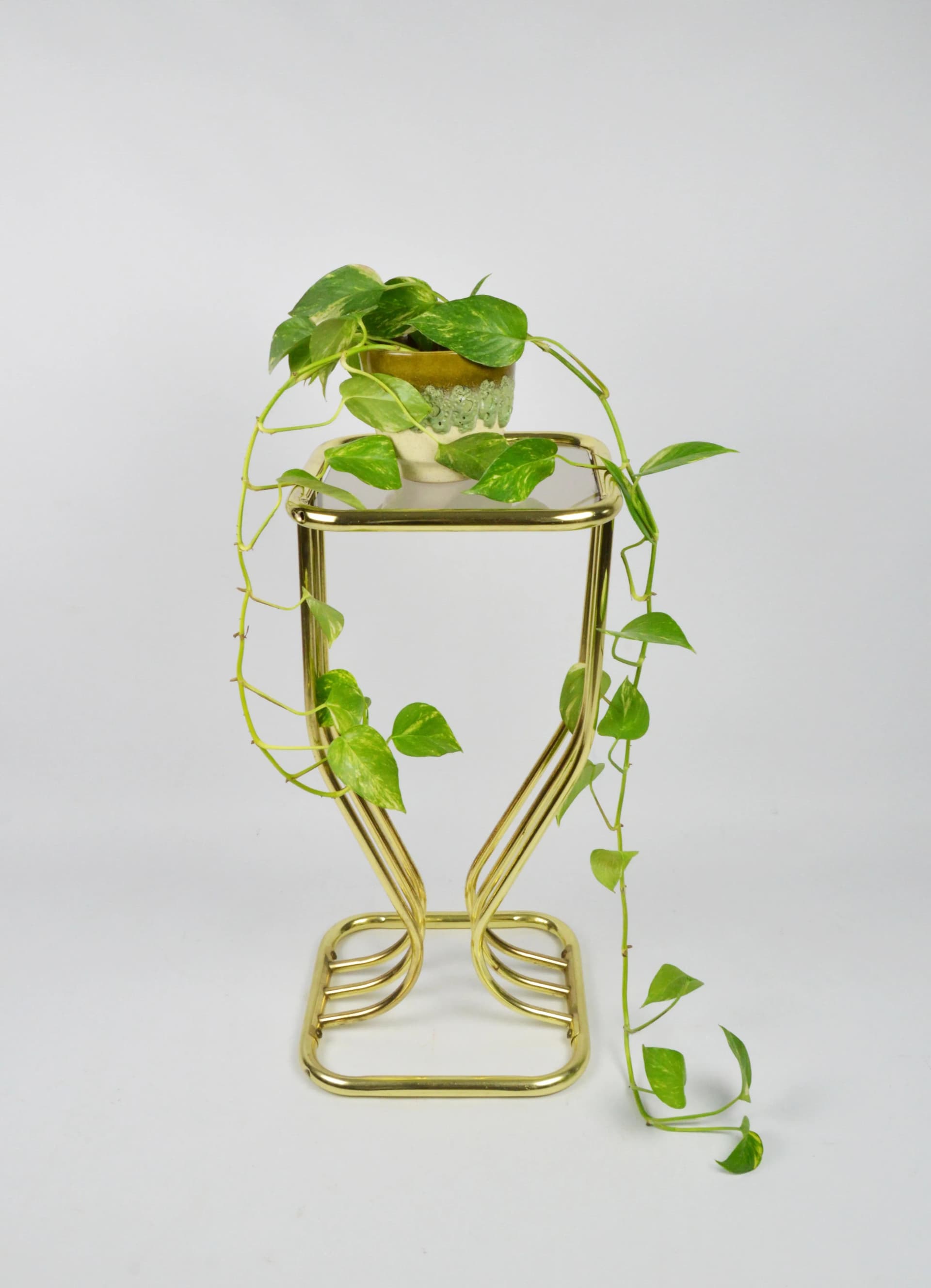 Plant stand Hollywood Regency, golden metal, smoked glass, Poland, 1980s. - 84479