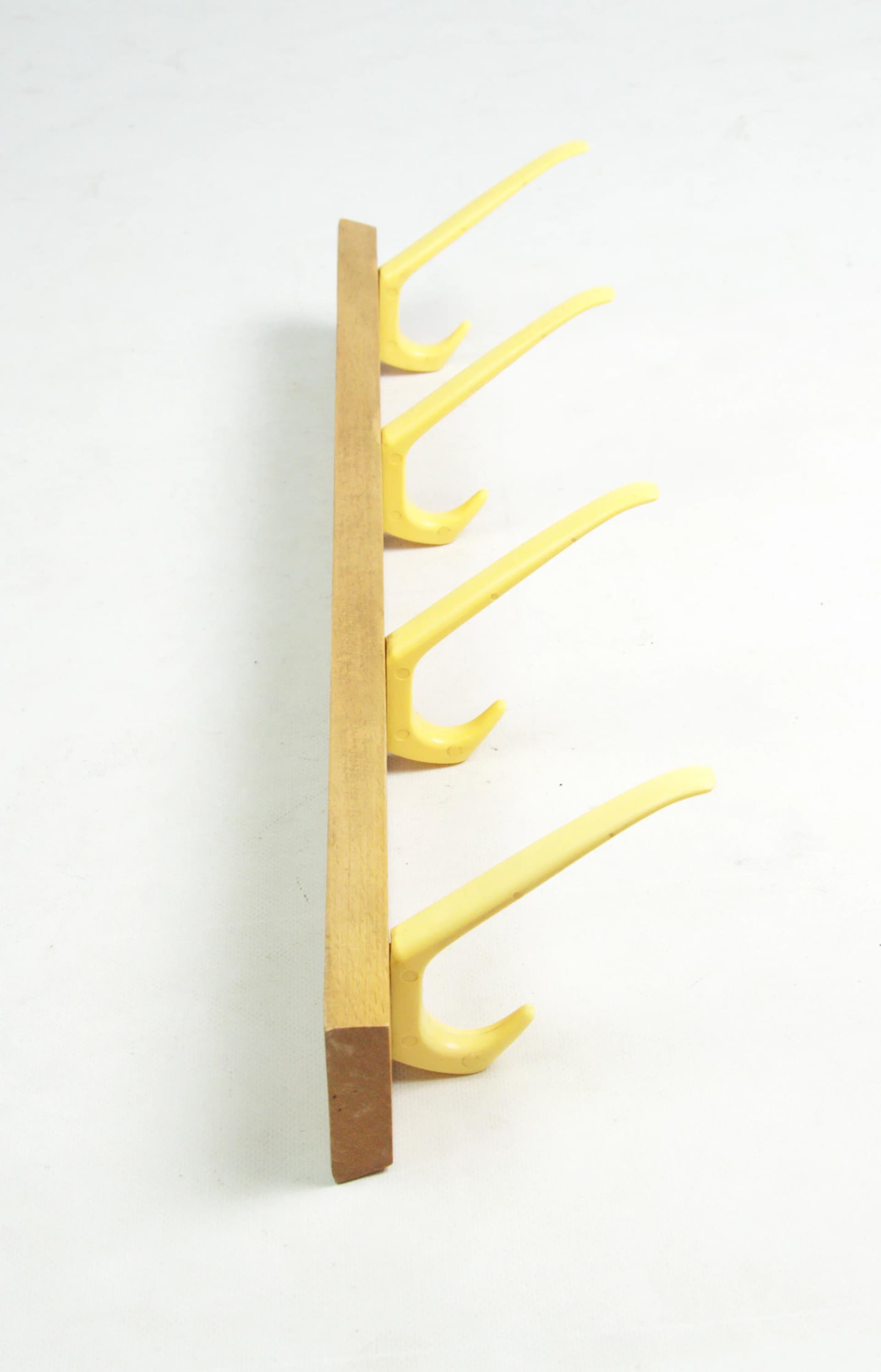 Wall-mounted rack, brown wood, yellow plastic, Germany, 1970s. - 83774