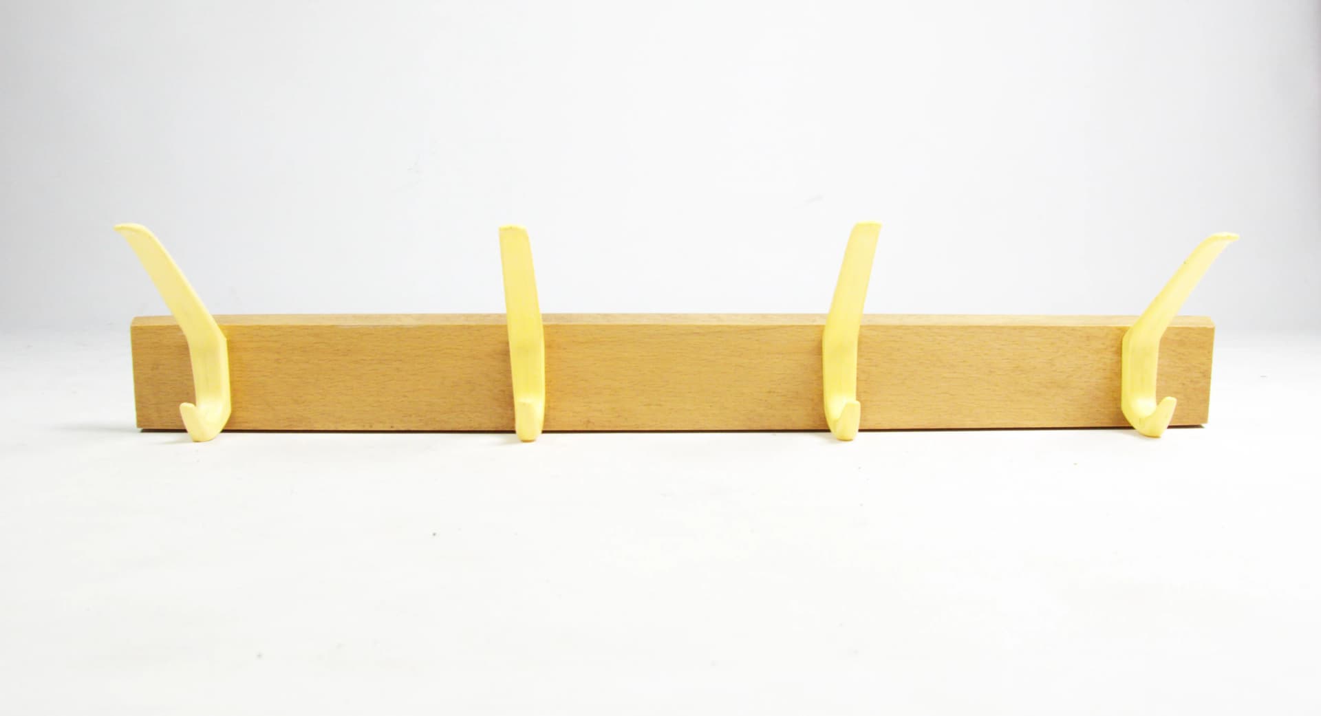 Wall-mounted rack, brown wood, yellow plastic, Germany, 1970s. - 83773