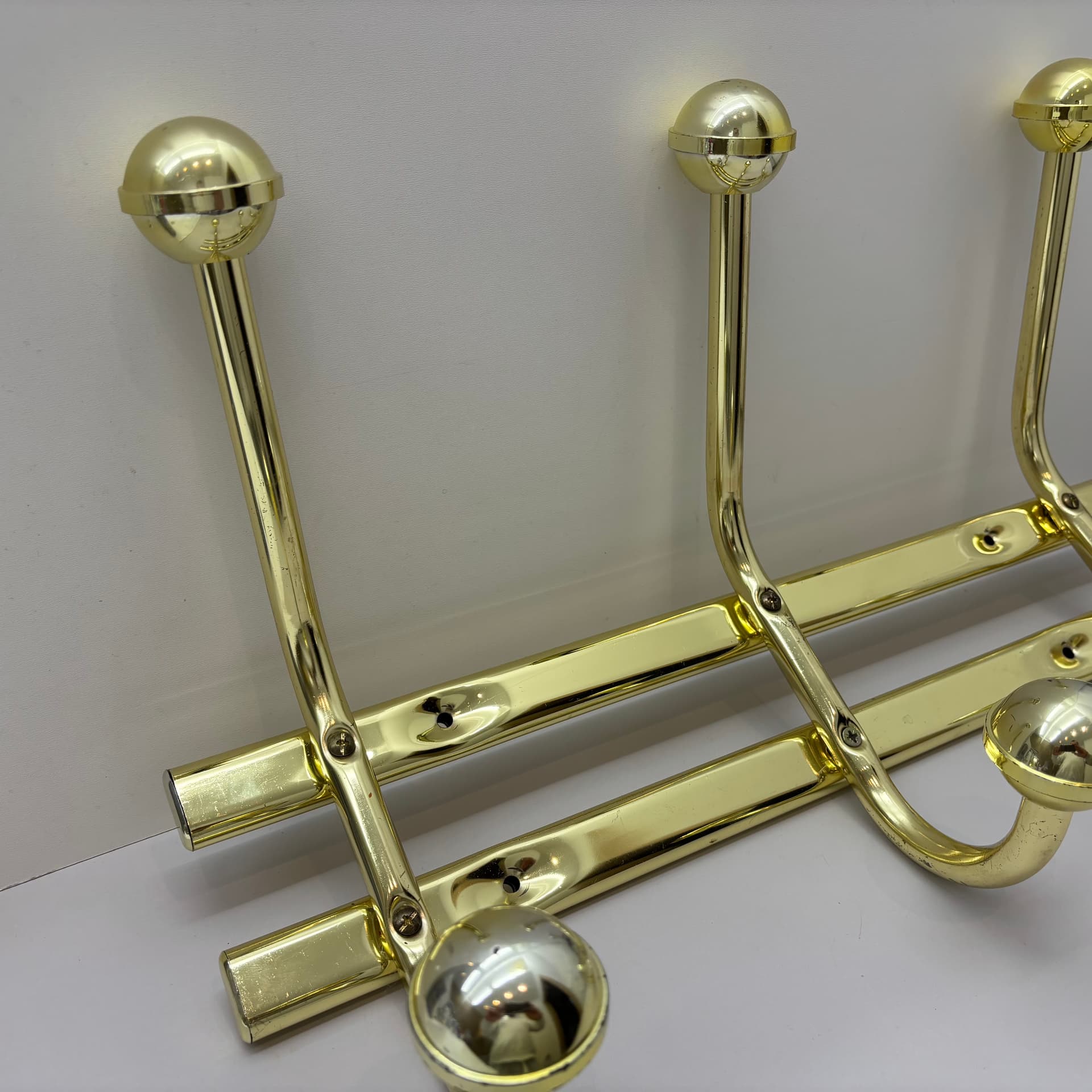 Wall-mounted rack, golden steel, Germany, 1970s. - 91489