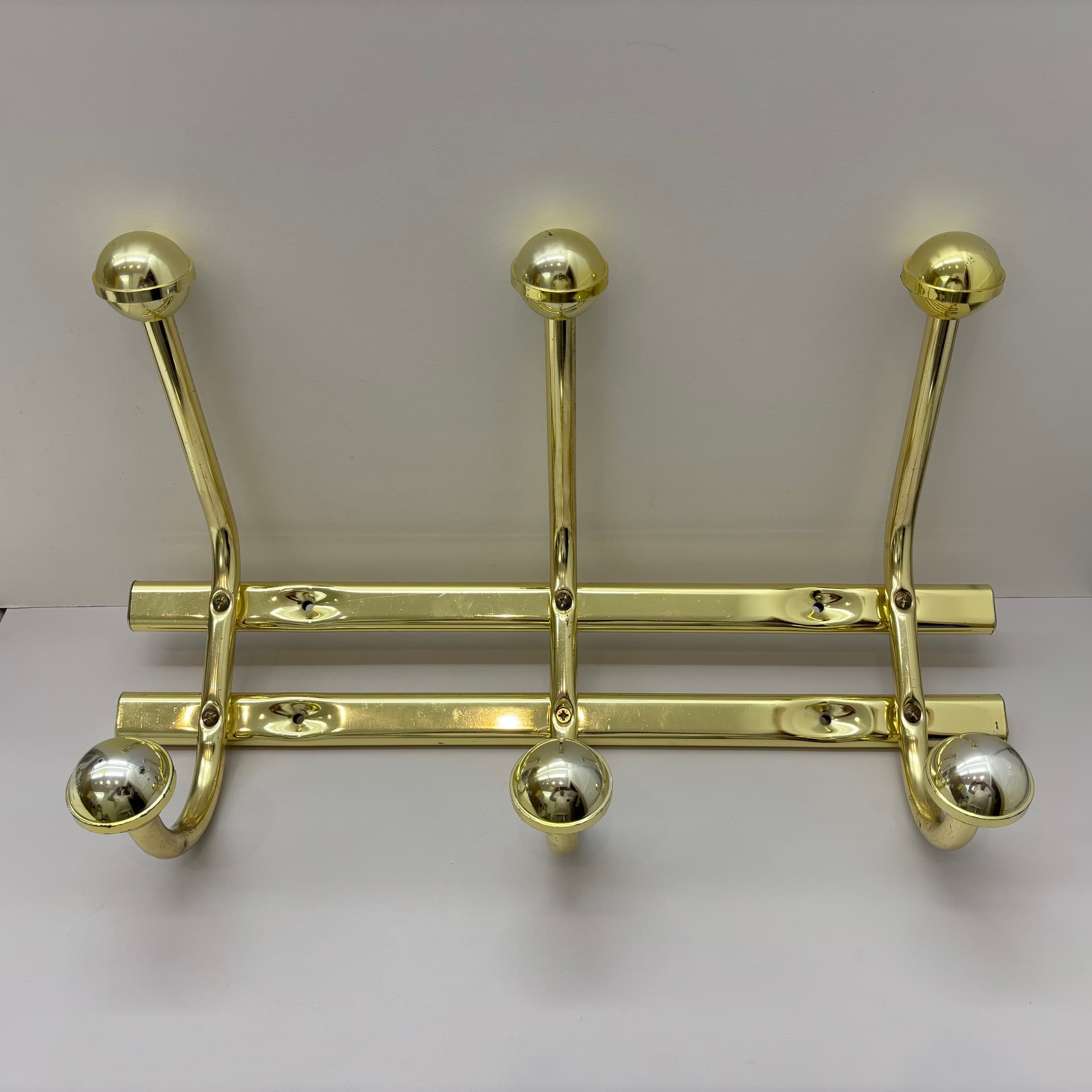 Wall-mounted rack, golden steel, Germany, 1970s. - 91490