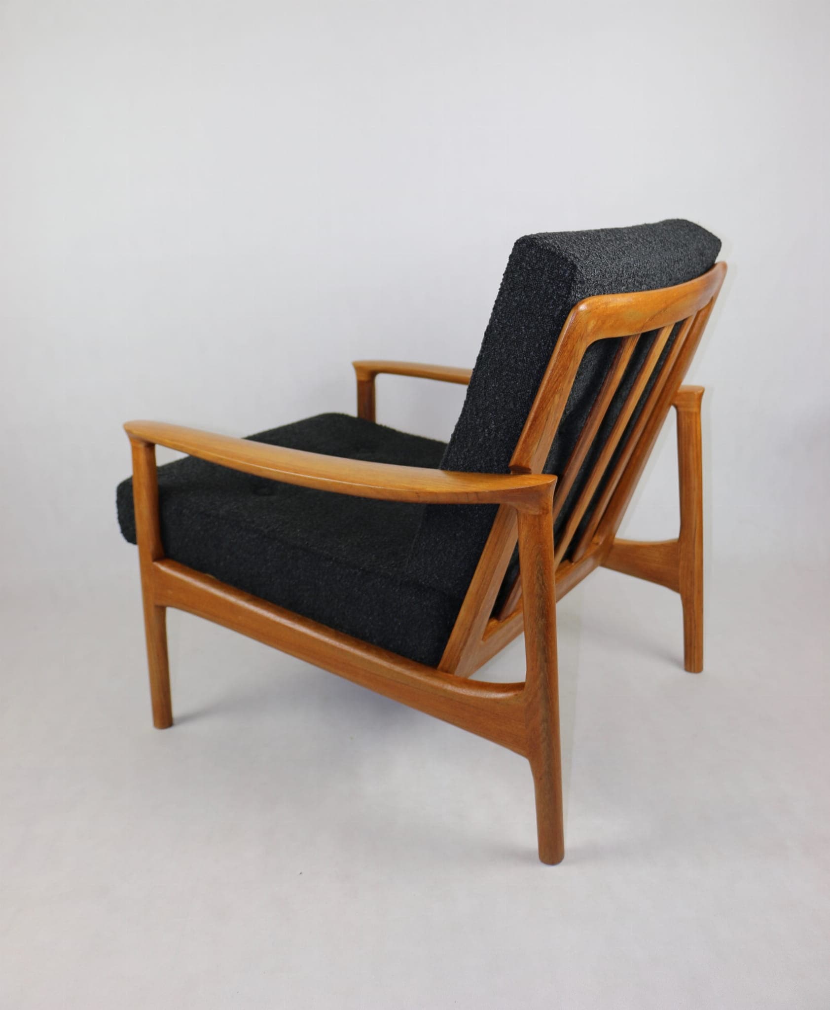 Armchair, black bouclé, teak, Denmark, 1970s. - 107291
