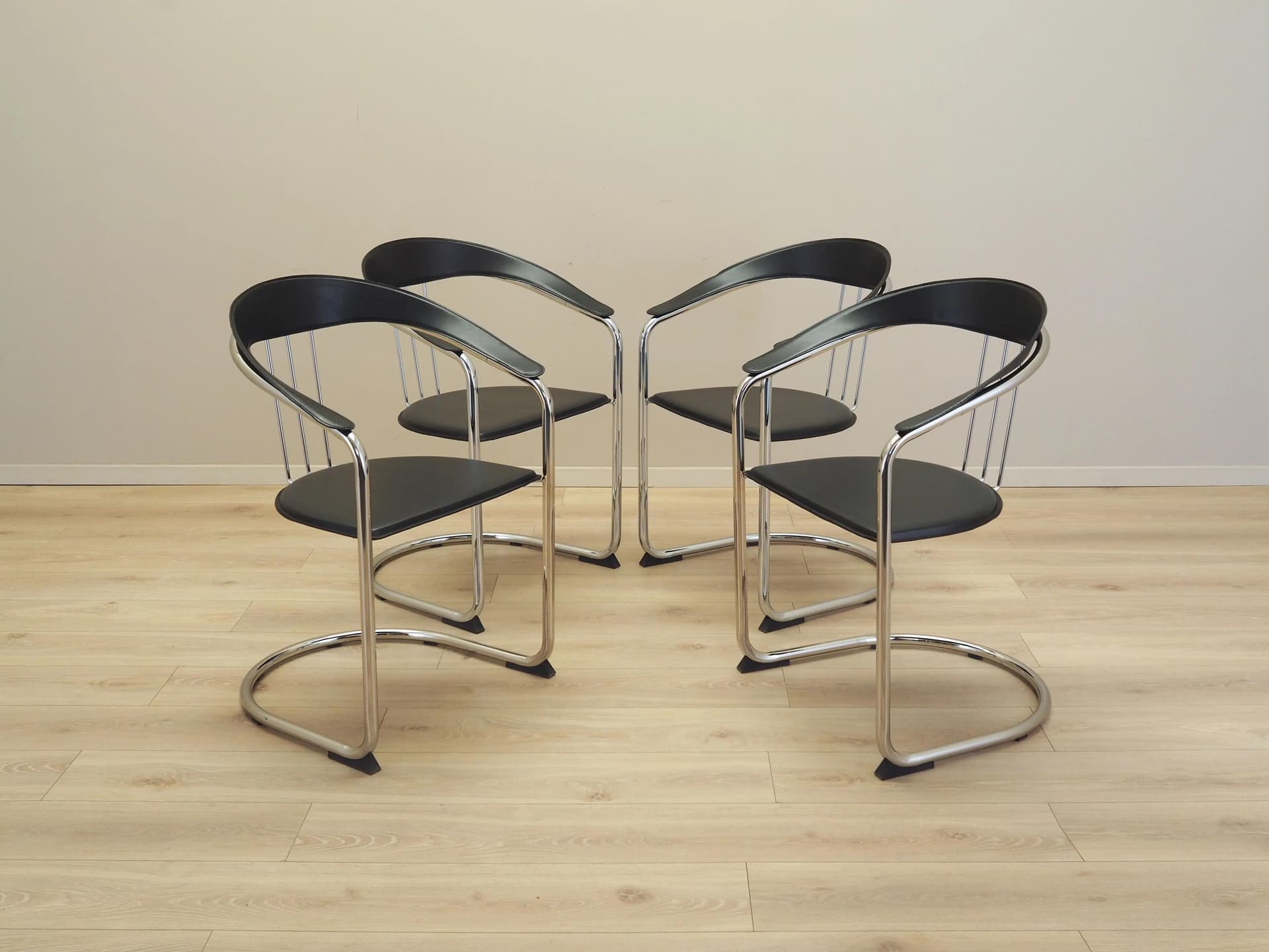 Set of four chairs, black leather, chromed metal, Italy, 1980s. - 22660
