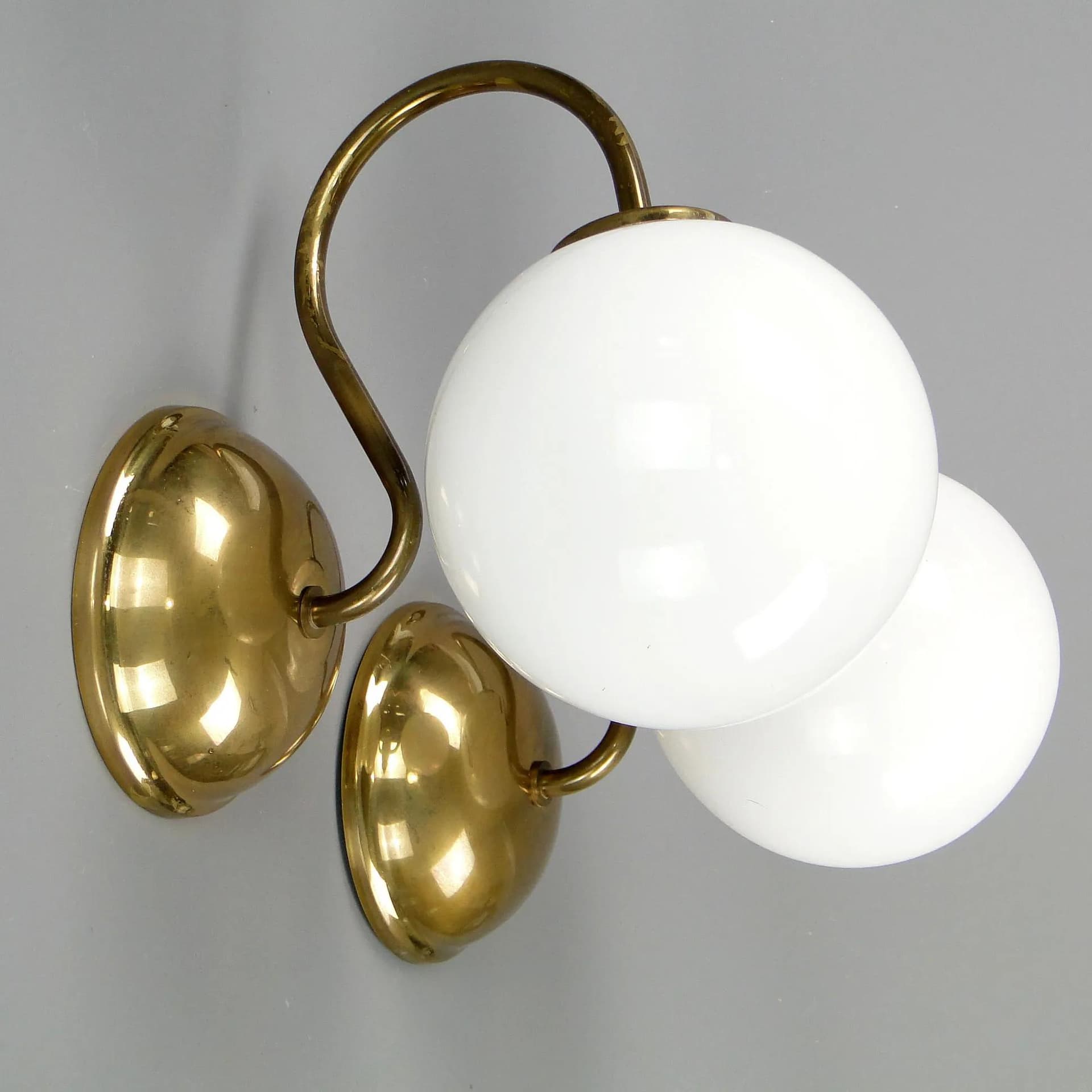 Pair of modernist wall sconces, golden brass, white glass, Poland, 1960s - 45348