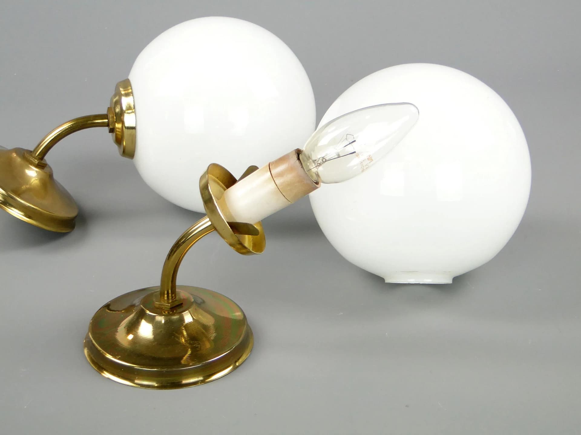 Pair of modernist wall sconces, golden brass, white glass, Poland, 1960s - 45341