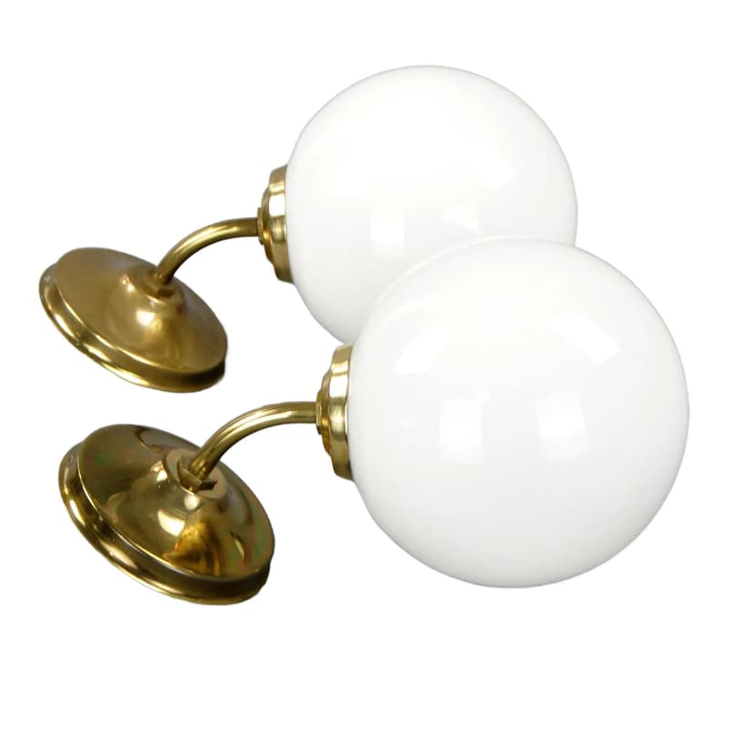 Pair of modernist wall sconces, golden brass, white glass, Poland, 1960s