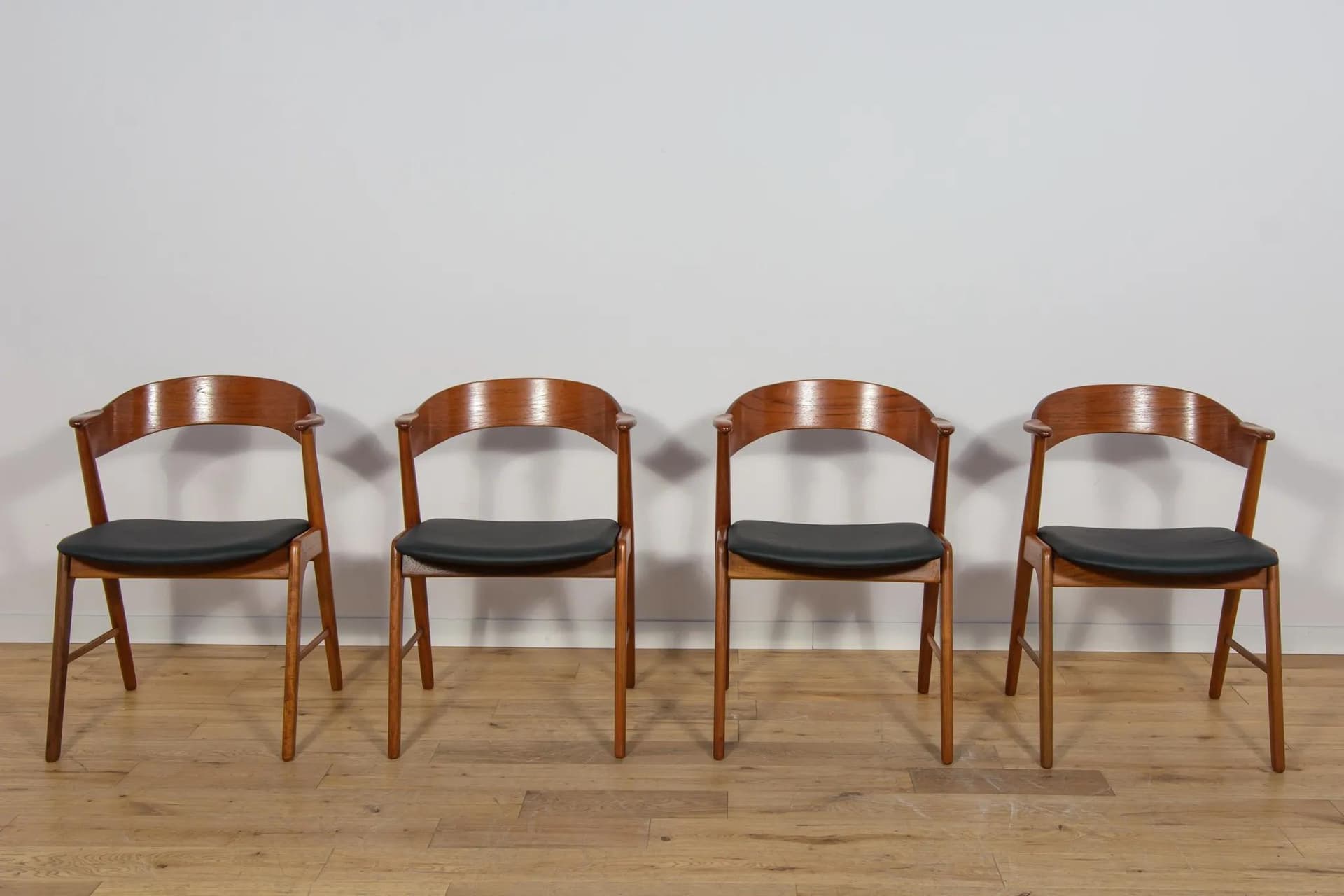 Set of four chairs, brown teak, black leather, Denmark, 1960s. - 70961